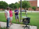With typical student ingenuity and a touch of "Texas Field-Expedient
Engineering," Jake Rhodes, KF5HYD (left), Court Sullivan, KF5HYE (center), and James Boshart, take the prototype unit mobile for a solar drift scan. [Larry D. Barr, K5WLF, Photo]
